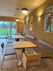 a dining room with wooden tables and chairs at B&B Zirbenduft in Ribnitz-Damgarten