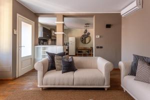 a living room with a couch and a kitchen at Suite Alzaia by iCasamia it in Milan