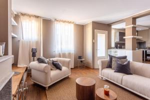 a living room with two couches and a table at Suite Alzaia by iCasamia it in Milan