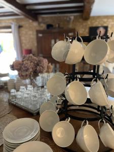 a group of cups and plates on a table at Hôtel La Villa Romaine in Carsac-Aillac