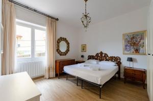 a bedroom with a large bed and a mirror at Casa degli artisti 1 in Casarza Ligure
