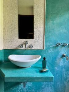 a bathroom with a white sink and a mirror at Hermosa Casa de campo con pileta in Río Ceballos