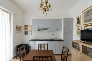 a kitchen with a table and chairs and a sink at Casa degli artisti 1 in Casarza Ligure