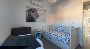 a bedroom with a bed and a picture of a horse at Villa Venna, with a private pool in Baños y Mendigo +28 photos