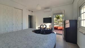 a bedroom with a bed with an umbrella on it at Villa Venna, with a private pool in Baños y Mendigo