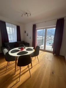 a living room with a table and chairs with a view at CityLake G23 Apartments in Gmunden