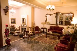 a living room filled with furniture and a mirror at Hotel Urania in Preveza