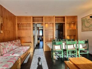 a room with a couch and a table and chairs at Appartement La Plagne, 3 pièces, 6 personnes - FR-1-455-54 in La Plagne
