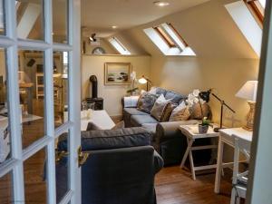 a living room with a couch and some skylights at The Barn in South Cerney