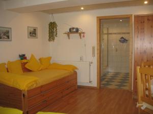 a bedroom with a bed with yellow pillows at Haus Edith Kempa in Sankt Aldegund