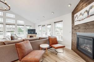a living room with a couch and a fireplace at The Capella in Pacific City