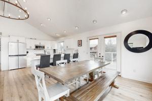 a kitchen and dining room with a wooden table and chairs at The Capella in Pacific City
