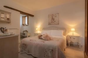 a bedroom with a bed with a stuffed animal on it at Agriturismo Renello in Petroio