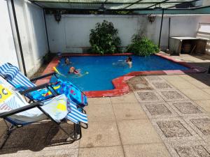 a group of people swimming in a swimming pool at Costanera Bed & Breakfast in Santiago