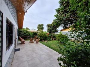 an outdoor patio with chairs and an umbrella at Casa Jade in Quintero