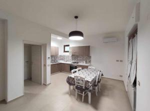 a kitchen with a table and chairs in a room at CASA VACANZE CASANOVA in Agerola