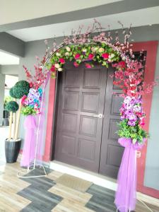 a door with a bunch of flowers in front of it at Weng Kong Homestay in Slim River