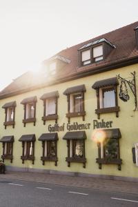 a building with a gourmet gardenerinder sign on it at Landgasthof Zum Goldenen Anker in Eggenstein-Leopoldshafen