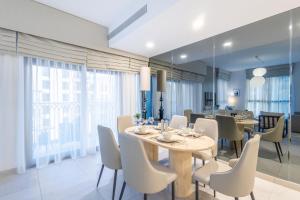 a dining room with a table and chairs at SuperHost - Urban Elegance 2BR in Asayel 2 Near Burj Al Arab in Dubai