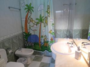 a bathroom with a sink and a toilet and a shower curtain at Casa Julieta in Altura +20 photos