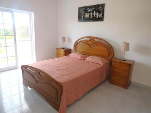 a bedroom with a large wooden bed and two night stands at Casa Julieta in Altura