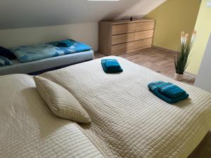 a large bed with two pillows on it in a bedroom at Ubytovani Nikol in Brno