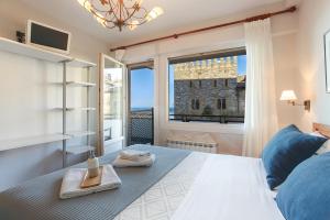 a bedroom with a bed with a large window at Pensión Zarauz Playa in Zarautz