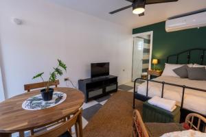 a living room with a bed and a table and a bedroom at El Flamingo Beach Club in Manati
