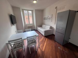 a living room with a table and chairs and a couch at Lecco Holiday Apartment in Lecco