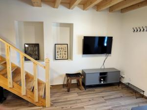 a living room with a flat screen tv on a wall at Casa Nº7 - Vila d'Óbidos in Óbidos