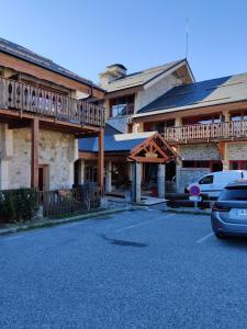 a large building with a car parked in front of it at Appartement 2/4 personnes in Bolquere Pyrenees 2000