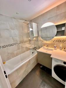 a bathroom with a shower and a sink and a tub at Cosy nest 6km from Paris in Le Plessis-Robinson