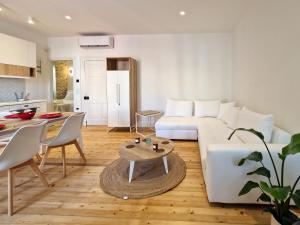 a living room with a white couch and a table at Vailato Swan White Suite in Corfu
