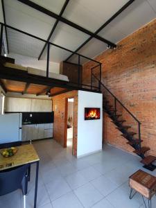 a living room with a fireplace and a brick wall at Palm Village in Nueva Italia