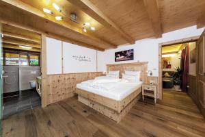 ein Schlafzimmer mit einem großen weißen Bett in einem Zimmer in der Unterkunft Bayern Chalets in Ainring