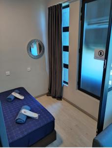 a room with a blue bed and a mirror at ArasTwo JQ Homestaykk LEVEL 22 SEAVIEW in Kota Kinabalu