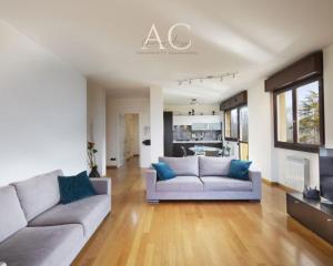 a living room with two couches and a kitchen at The House on the Lake in Reno Di Leggiuno