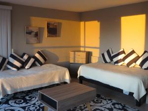 a hotel room with two beds and a table at Mirador de San Miguel in San Miguel de Allende