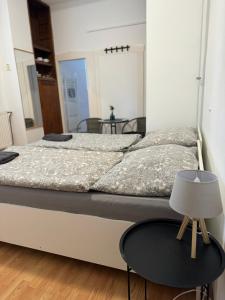 a bedroom with a large bed with a table at Pension Moravia in Olomouc