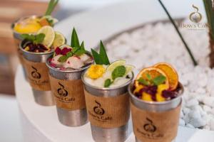 a row of cups filled with different types of desserts at Lavender Tan Thanh Hotel mini resort in Cong Thanh (3)