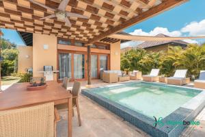a villa with a swimming pool and a table and chairs at Full of life! Green Village w private pool 28A in Punta Cana