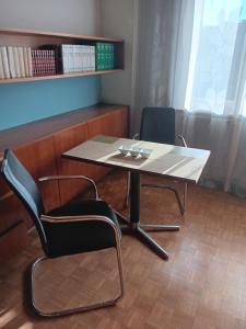 a table and two chairs in a room at Ländlezimmer in Rankweil