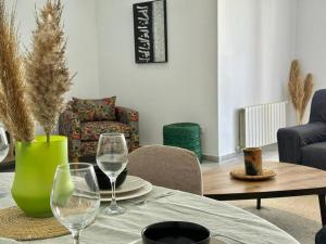 a table with two wine glasses and a vase at Saf-Saf Apartment 2 in La Marsa