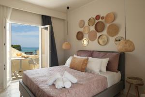 a bedroom with a bed with a view of the ocean at Del Mare Beach Hotel in Sidari