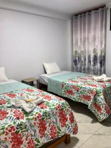 two beds sitting next to each other in a room at Áncora Beach Hotel in Máncora +9 photos