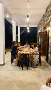 a group of people sitting at a table eating at Simplex Sea Place in Tangalle
