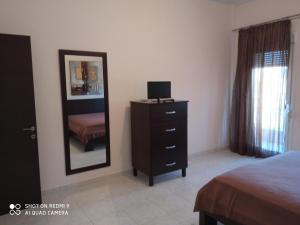 a bedroom with a dresser with a mirror and a bed at serres center in Serres