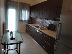a kitchen with black cabinets and a table in it at serres center in Serres