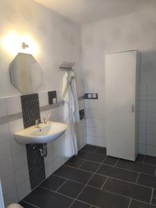 a bathroom with a sink and a mirror at Ferienwohnung Liane in Federow
