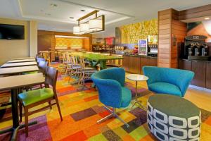 a restaurant with colorful chairs and tables and a bar at Fairfield Inn and Suites Memphis Germantown in Memphis